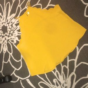 Gold tank with scallop arm.